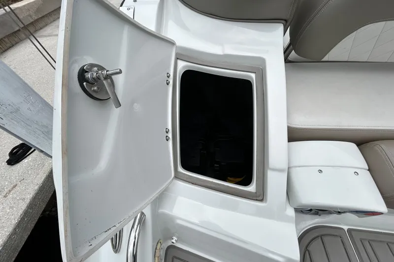 Slide: The Image of Open storage compartment on 2022 Crownline 270 XSS boat with seating area. - 52