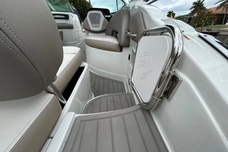 Slide: The Image of 2022 Crownline 270 XSS boat interior with seating and storage compartments. - 56