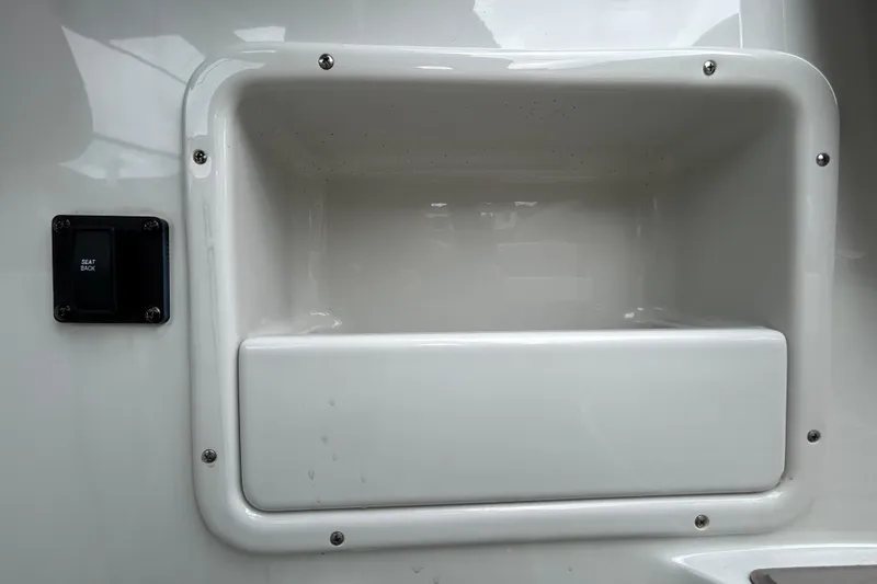 Slide: The Image of Crownline 270 XSS 2022 boat compartment with seat back switch. - 58