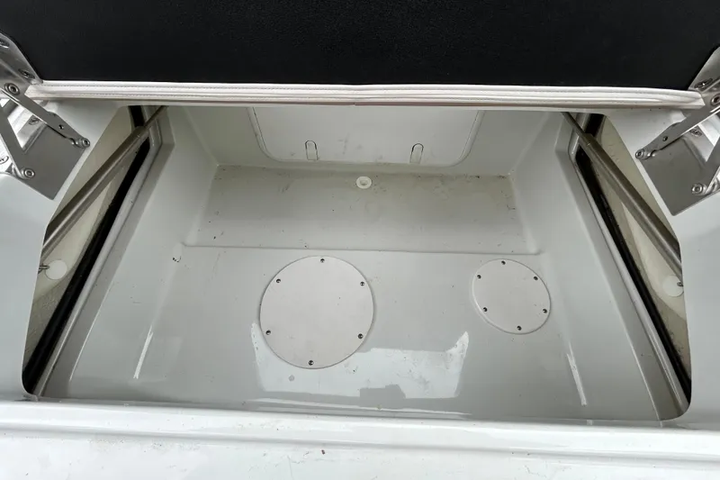 Slide: The Image of Open storage compartment in a 2022 Crownline 270 XSS boat, showcasing interior space. - 64