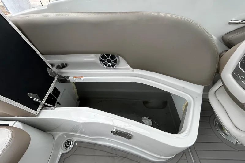 Slide: The Image of 2022 Crownline 270 XSS boat interior seating with speaker and cup holders. - 67