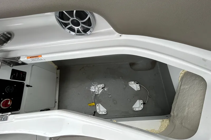 Slide: The Image of 2022 Crownline 270 XSS boat storage compartment with open hatch and speaker. - 68