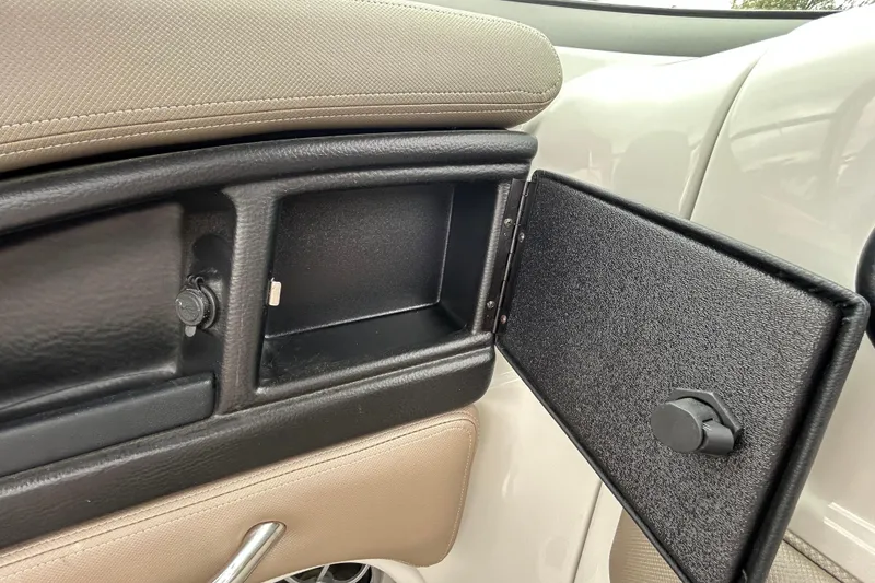 Slide: The Image of 2022 Crownline 270 XSS boat interior with black leather panel and USB port. - 71