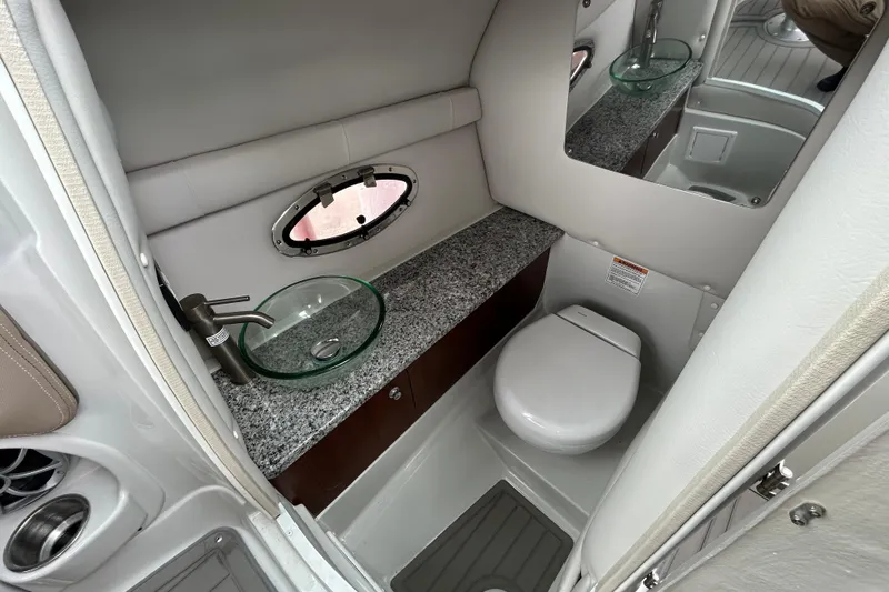 Slide: The Image of 2022 Crownline 270 XSS boat bathroom with granite countertop and modern fixtures. - 75