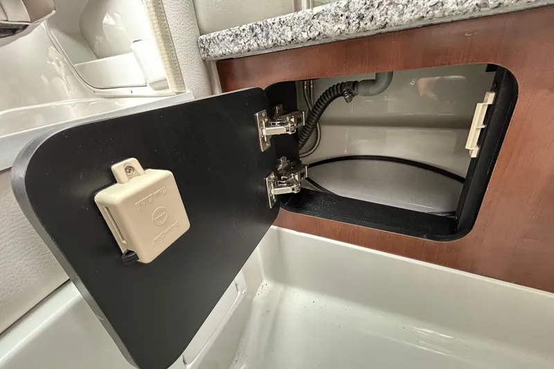 Slide: The Image of Wooden panel with a chrome handle on a 2022 Crownline 270 XSS boat. - 77