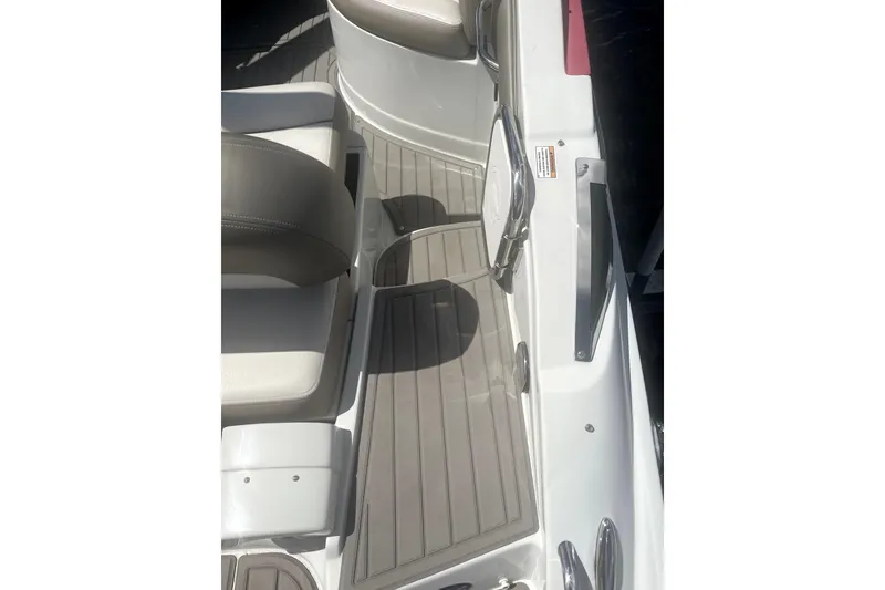 Slide: The Image of 2022 Crownline 270 XSS boat interior with gray flooring and seating. - 8