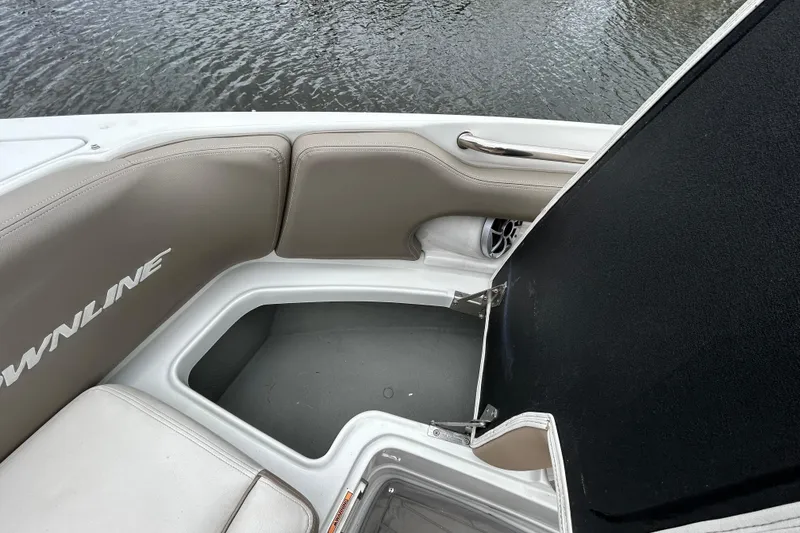 Slide: The Image of 2022 Crownline 270 XSS boat storage compartment with lock, featuring sleek design. - 88