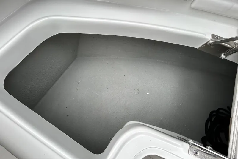 Slide: The Image of Open storage compartment on 2022 Crownline 270 XSS boat, showing interior space. - 89