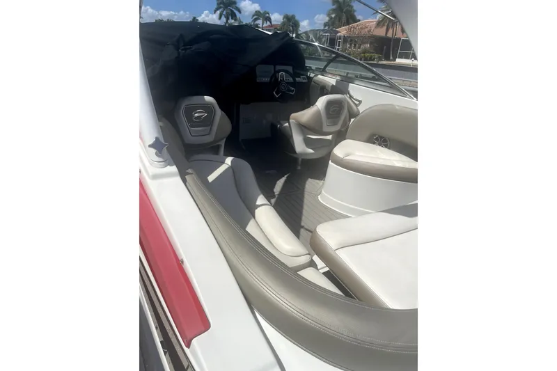 Slide: The Image of 2022 Crownline 270 XSS boat interior with seating and steering wheel. - 9
