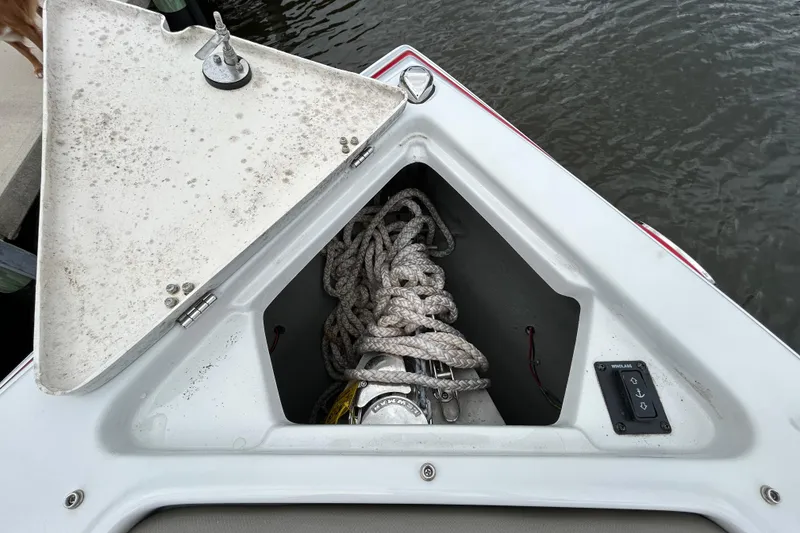 Slide: The Image of 2022 Crownline 270 XSS boat interior with cushioned seating and speaker. - 98