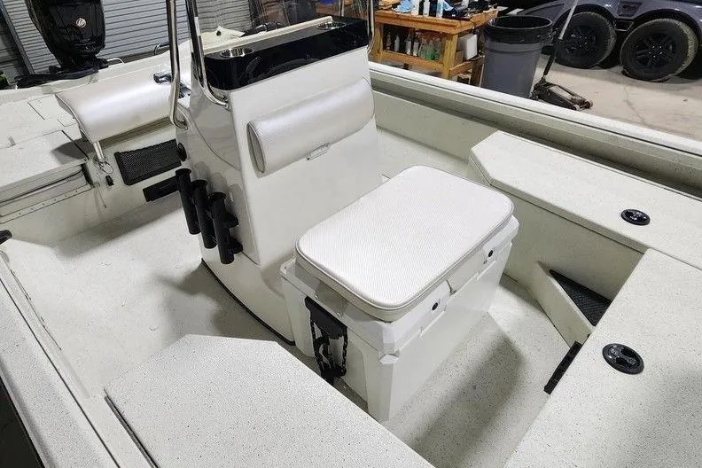 Slide: The Image of 2026 Ranger RB190 boat interior with seating and storage in a garage setting. - 11