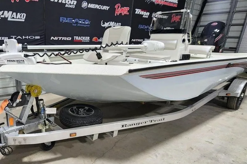 Slide: The Image of 2026 Ranger RB190 boat on trailer in showroom, featuring Minn Kota trolling motor. - 14