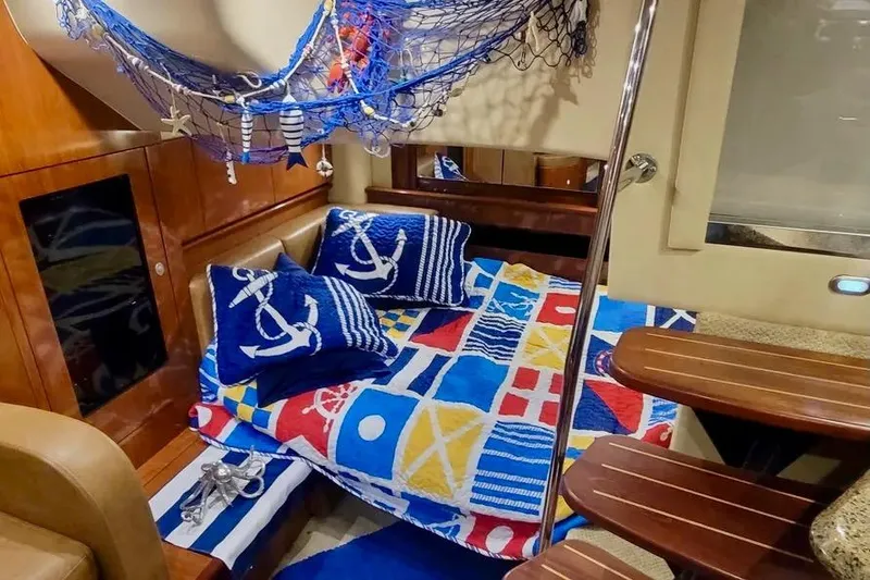 Slide: The Image of Nautical-themed cabin interior of 2005 Sea Ray 390 Sundancer with colorful bedding and decor. - 12