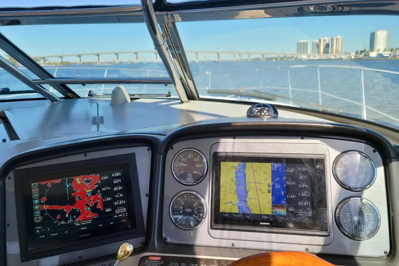 Slide: The Image of Helm of 2005 Sea Ray 390 Sundancer with navigation screens and gauges, cityscape in background. - 17