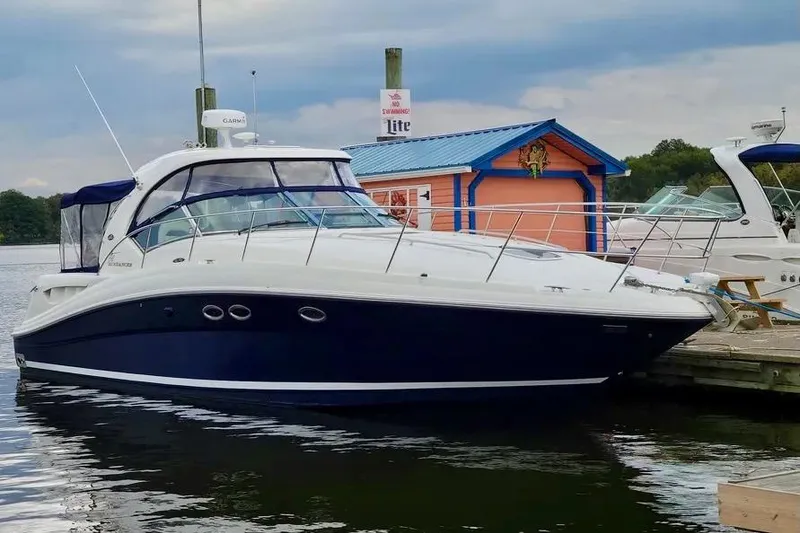 Slide: The Image of 2005 Sea Ray 390 Sundancer yacht docked by colorful boathouse. - 5