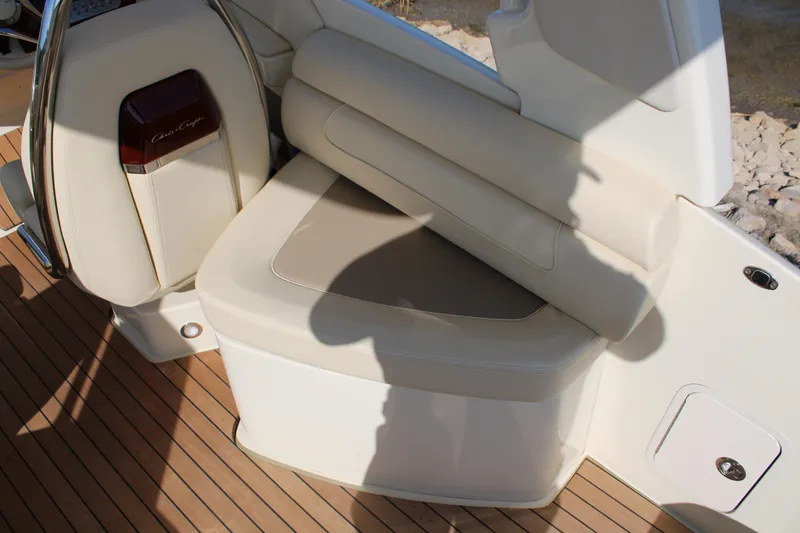 Slide: The Image of 2025 Chris Craft Launch 28 GT boat interior with luxurious seating and wood flooring. - 10