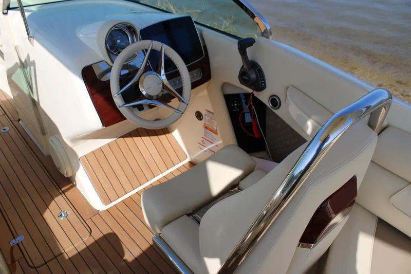 Slide: The Image of 2025 Chris Craft Launch 28 GT helm with sleek design and modern controls. - 12