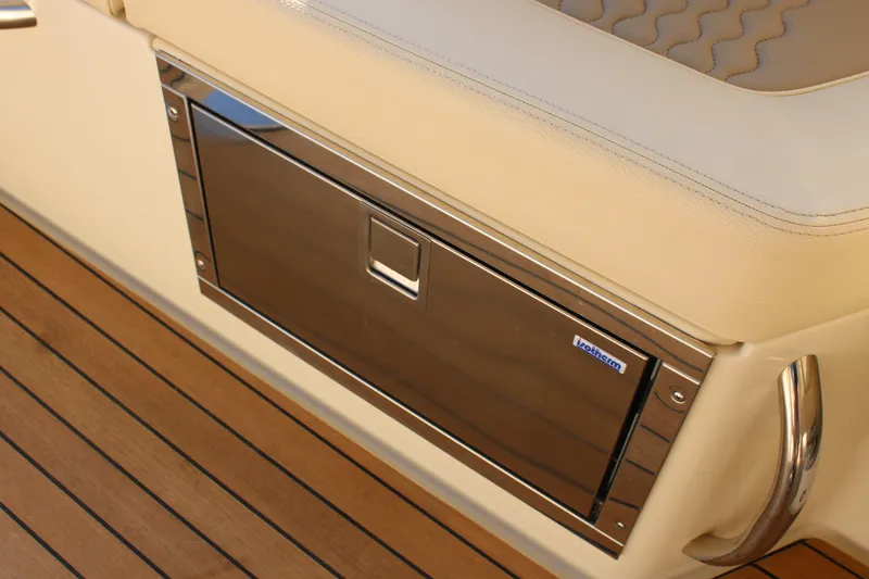 Slide: The Image of 2025 Chris Craft Launch 28 GT interior detail with stainless steel storage and beige seating. - 15