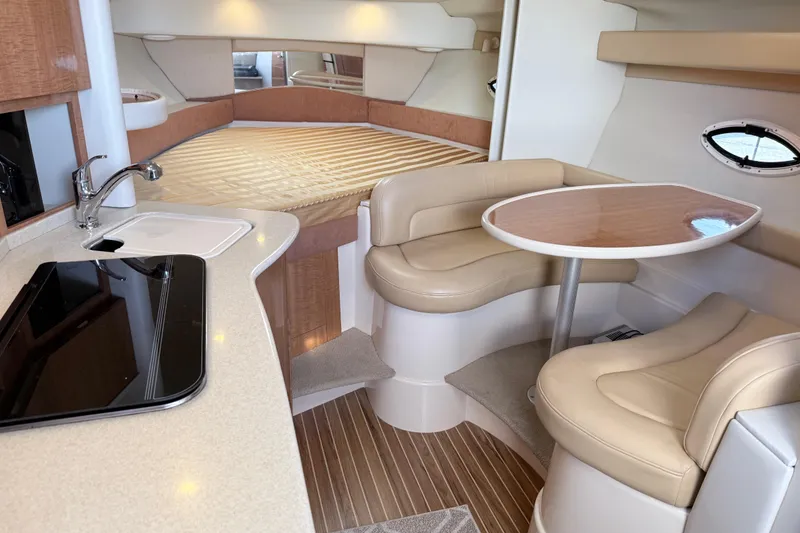 Slide: The Image of Interior of 2002 Maxum 3100 SE boat with kitchenette, dining area, and bed. - 10