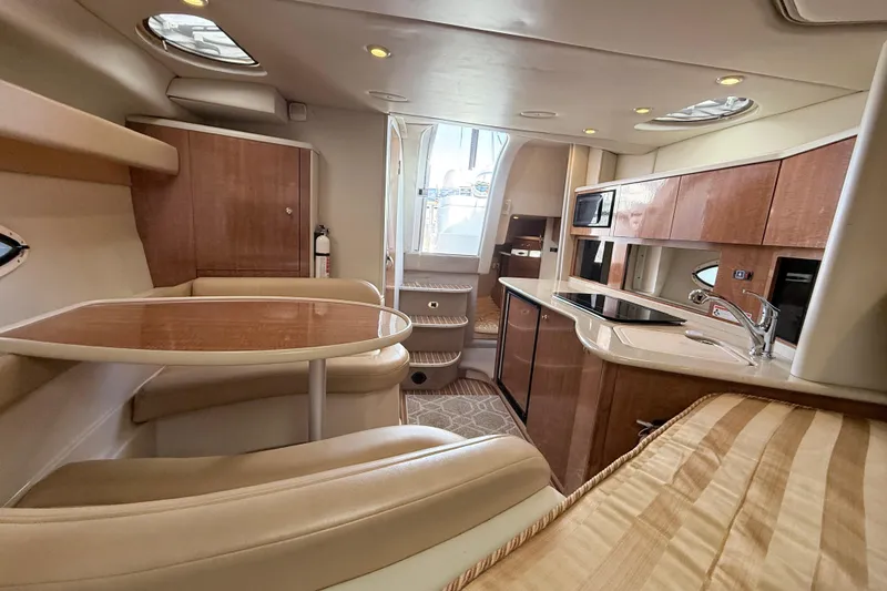 Slide: The Image of Luxurious interior of 2002 Maxum 3100 SE yacht with modern kitchen and seating area. - 11