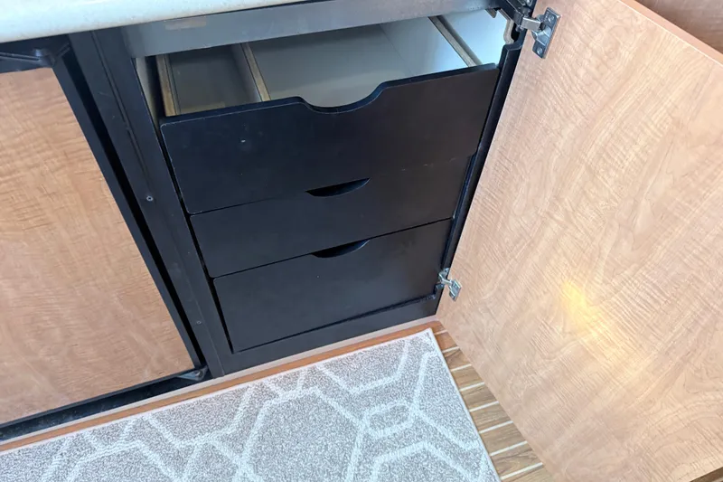 Slide: The Image of Black drawers inside a wooden cabinet on a 2002 Maxum 3100 SE boat. - 14