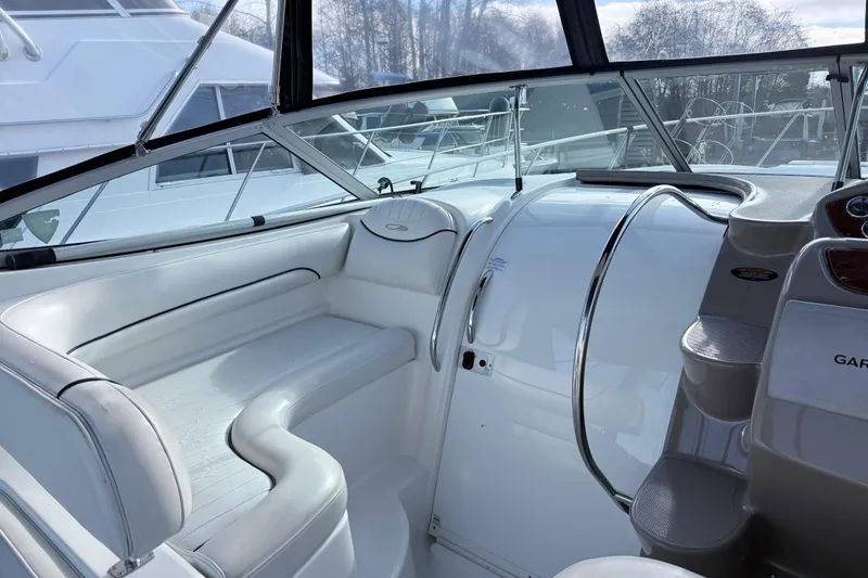 Slide: The Image of 2002 Maxum 3100 SE boat interior with white seating and control panel. - 6