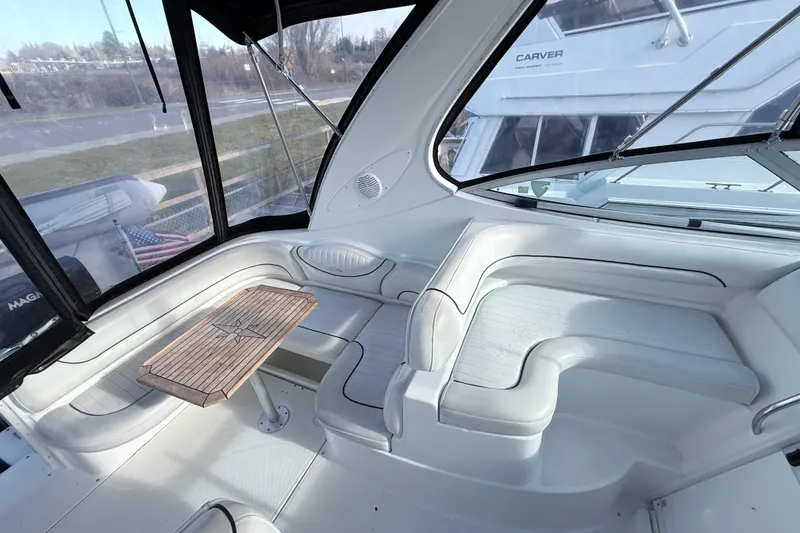 Slide: The Image of 2002 Maxum 3100 SE boat interior with white seating and wooden table. - 9