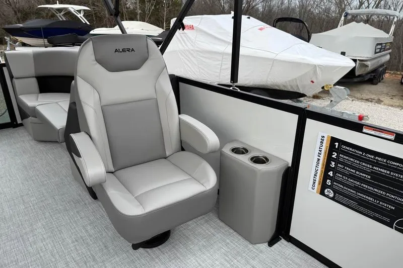 Slide: The Image of 2026 Alara 22Q boat interior with gray captain's chair and cup holders. - 13
