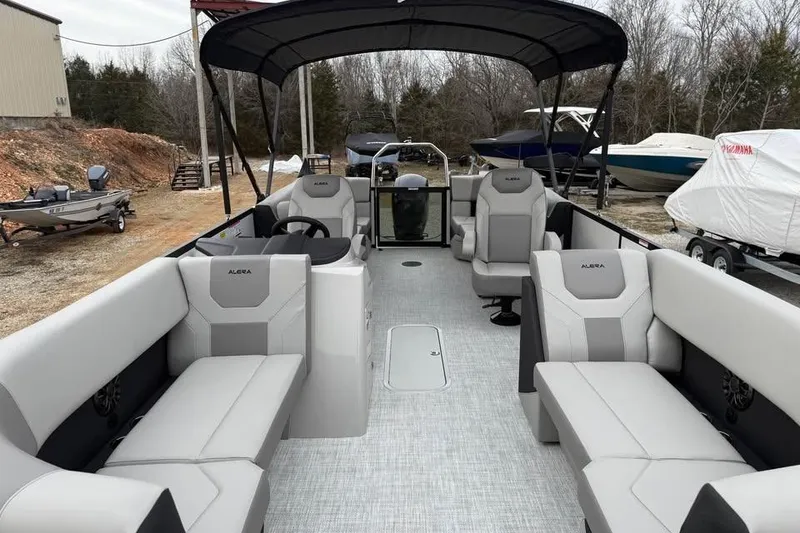 Slide: The Image of 2026 Alara 22Q pontoon boat with spacious seating and canopy, parked outdoors. - 15