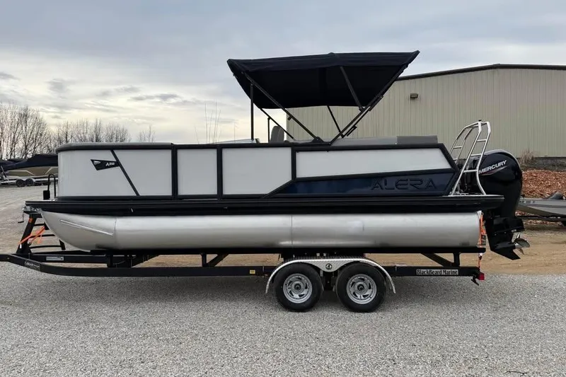 Slide: The Image of 2026 Alara 22Q pontoon boat on trailer, featuring a Mercury engine and canopy. - 4
