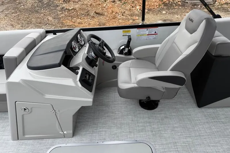 Slide: The Image of 2026 Alara 22q boat interior with steering console and comfortable seating. - 9
