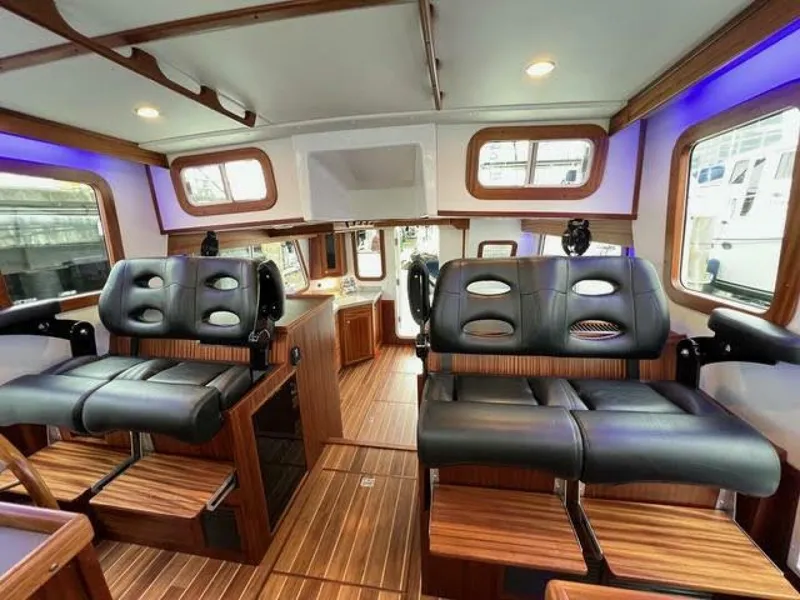 Slide: The Image of Interior of 2024 Nordic Tug 40 with luxurious seating and wood accents. - 13