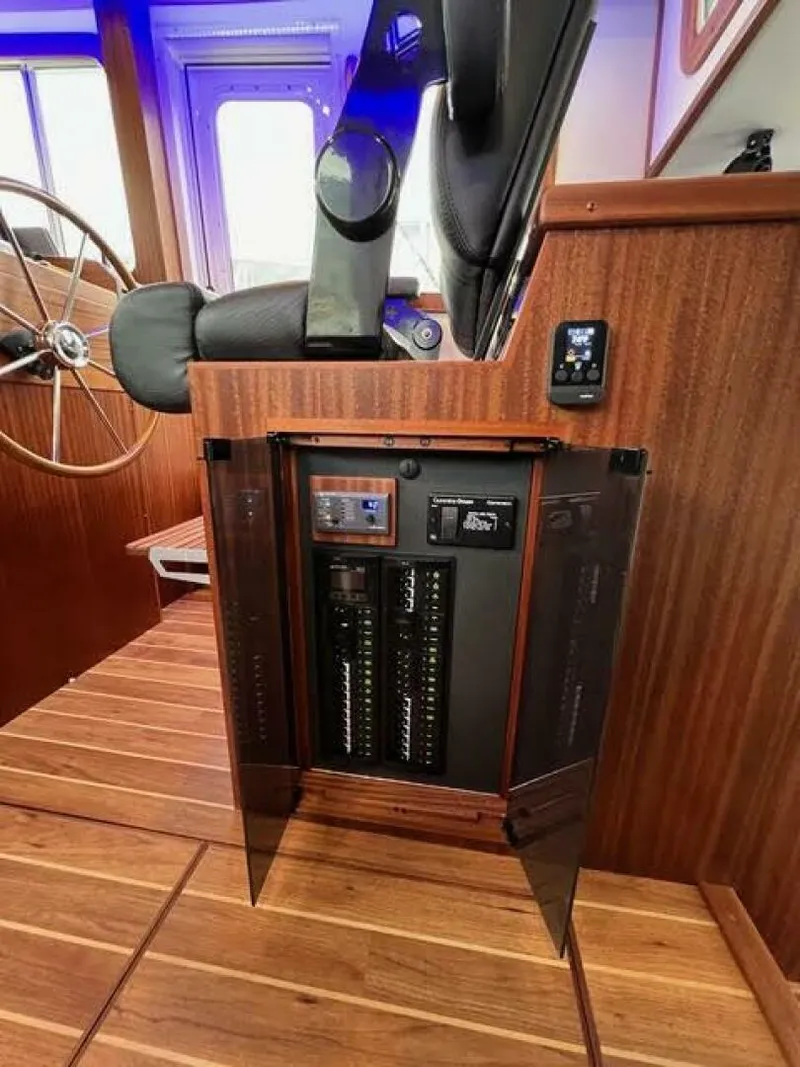 Slide: The Image of 2024 Nordic Tug 40 interior with control panel and wooden finish. - 14