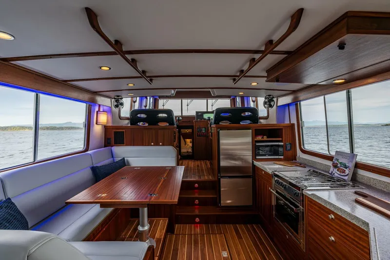 Slide: The Image of Luxurious interior of 2024 Nordic Tug 40 yacht with modern kitchen and dining area. - 3