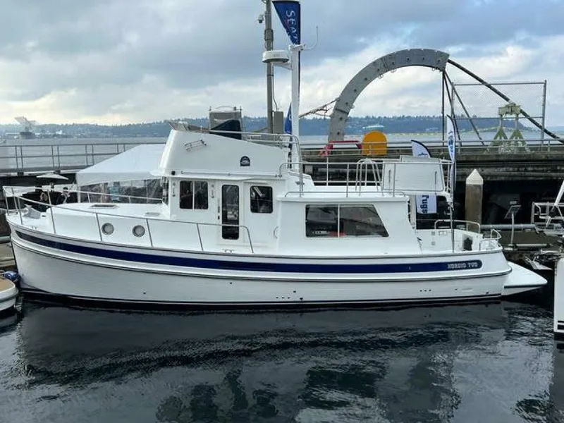 Slide: The Image of 2024 Nordic Tug 40 docked at a marina under cloudy skies. - 36