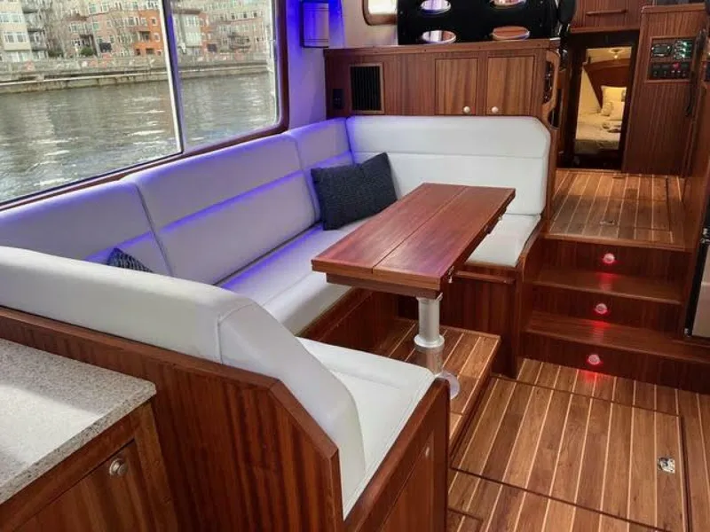 Slide: The Image of Luxurious interior of 2024 Nordic Tug 40 with wood accents and comfortable seating. - 4