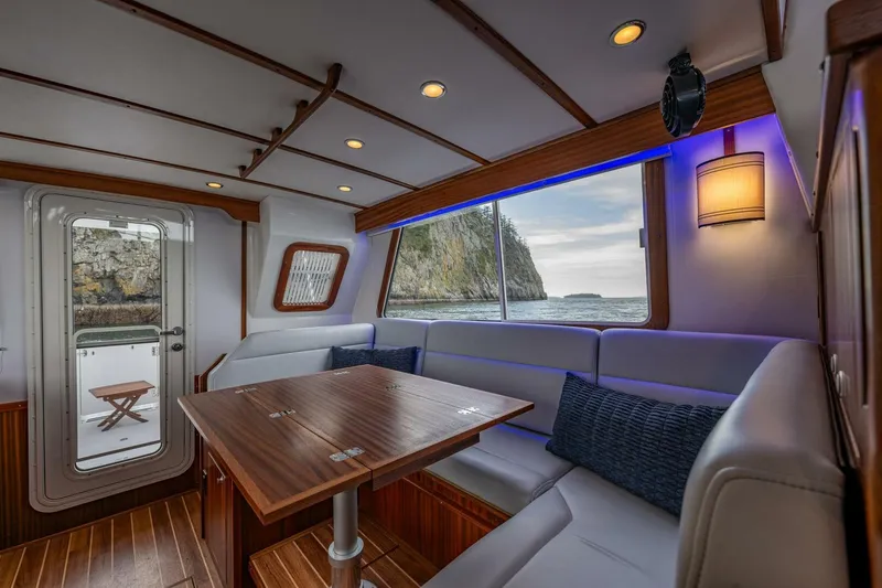 Slide: The Image of Luxurious interior of 2024 Nordic Tug 40 with ocean view and elegant seating area. - 8