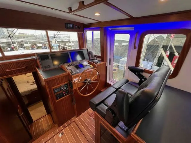 Slide: The Image of 2024 Nordic Tug 40 helm with modern controls and comfortable seating. - 9