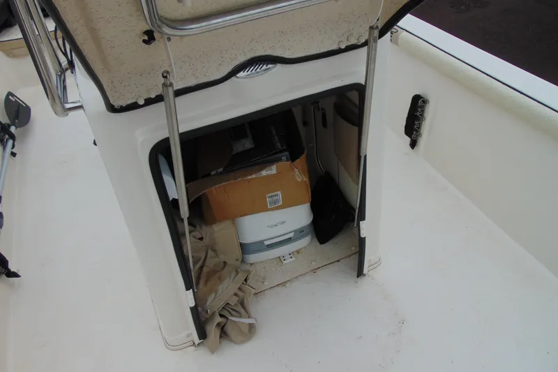 Slide: The Image of 2020 Carolina Skiff 21 LS boat storage compartment with various items inside. - 14