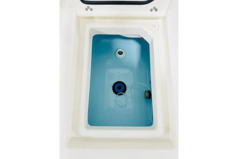 Slide: The Image of Livewell compartment of 2026 Pathfinder 2200 TRS boat, featuring a clean, white interior. - 14