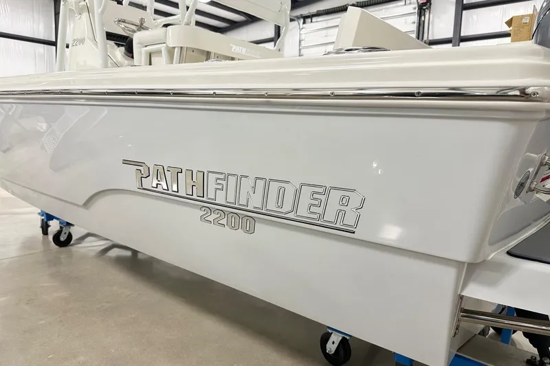 Slide: The Image of 2026 Pathfinder 2200 TRS boat in showroom, showcasing sleek design and branding. - 17
