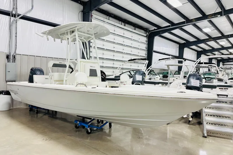 The Image of 2026 Pathfinder 2200 TRS boat displayed in a showroom with other boats. - 4
