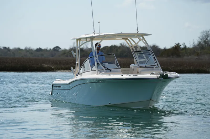 Slide: The Image of 2021 Grady-White Freedom 235 boat cruising on calm water. - 11