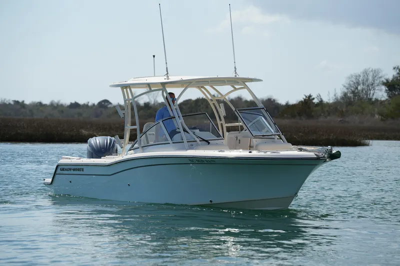 Slide: The Image of 2021 Grady-White Freedom 235 boat cruising on calm water. - 12