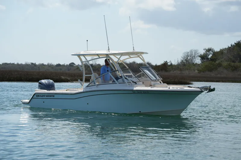 Slide: The Image of 2021 Grady-White Freedom 235 boat cruising on calm water. - 13