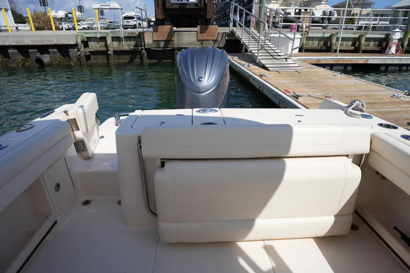 Slide: The Image of 2021 Grady-White Freedom 235 boat interior with seating and dock view. - 20