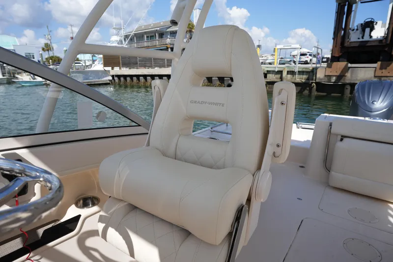 Slide: The Image of 2021 Grady-White Freedom 235 boat seat, luxurious design, dockside view. - 26
