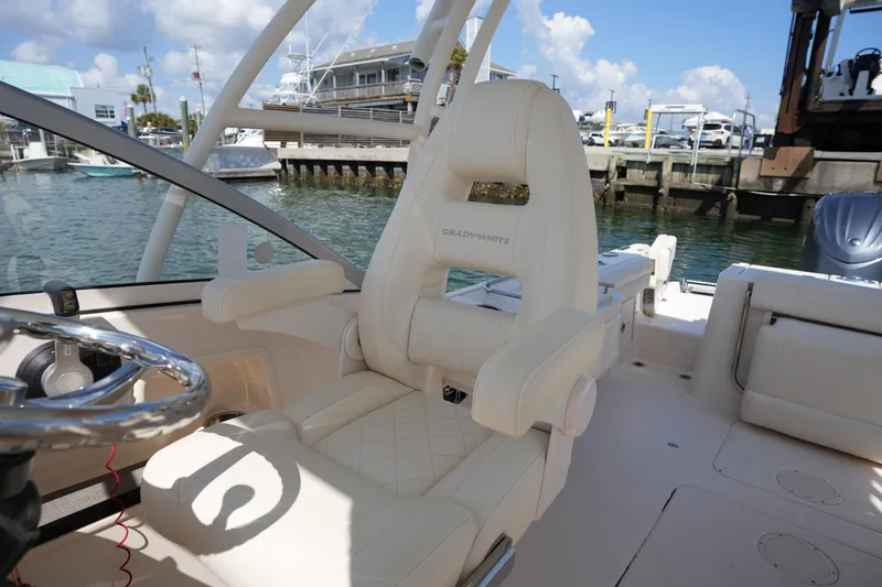 Slide: The Image of 2021 Grady-White Freedom 235 boat interior with helm seat and steering wheel. - 27