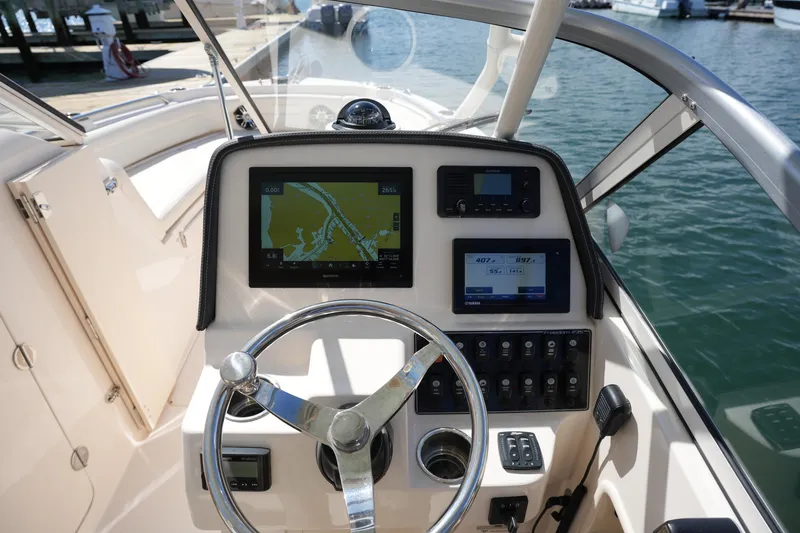 Slide: The Image of 2021 Grady-White Freedom 235 boat dashboard with navigation and control systems. - 31