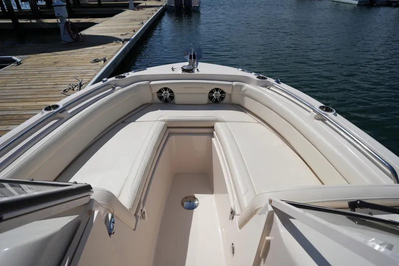 Slide: The Image of 2021 Grady-White Freedom 235 boat interior with cushioned seating at dock. - 35